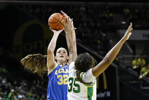 UCLA forward Angela Dugalic (32) shoots against Oregon forward Ehis Etute (35) in the second half of an NCAA college basketball game in Eugene, Ore., Sunday, Feb. 9, 2025. UCLA beat Oregon 62-52. (AP Photo/Thomas Boyd)