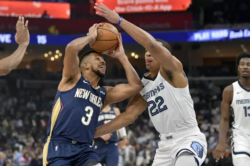 New Orleans Pelicans guard CJ McCollum (3) drives against Memphis Grizzlies guard Desmond Bane (22) during the first half of an NBA basketball game Wednesday, Oct. 25, 2023, in Memphis, Tenn. (AP Photo/Brandon Dill)