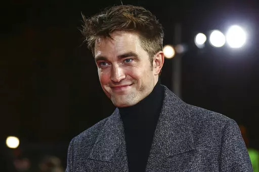Robert Pattinson poses for photographers upon arrival for the screening of the film 'The Batman' in London Wednesday, Feb. 23, 2022. (Photo by Joel C Ryan/Invision/AP)