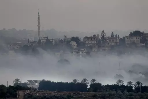 Israeli artillery shelling smoke covers Dahaira, a Lebanese border village with Israel, south Lebanon, Monday, Oct. 16, 2023. Lebanon's militant Hezbollah group says its fighters have targeted an Israeli position along the border directly hitting a Merkava tank. (AP Photo/Hussein Malla)