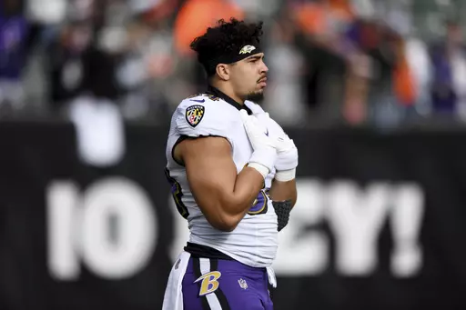 Baltimore Ravens tight end Josh Oliver looks on before an NFL football game against the Cincinnati Bengals on Jan. 8, 2023, in Cincinnati. The Minnesota Vikings ramped up their run blocking on Monday, March 13, 2023, by agreeing to terms with Oliver on a three-year, $21 million contract, according to a person with direct knowledge of the deal. (AP Photo/Emilee Chinn, File)