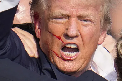 Republican presidential candidate former President Donald Trump reacts following an assassination attempt at a campaign event in Butler, Pa., on Saturday, July 13, 2024. (AP Photo/Gene J. Puskar)