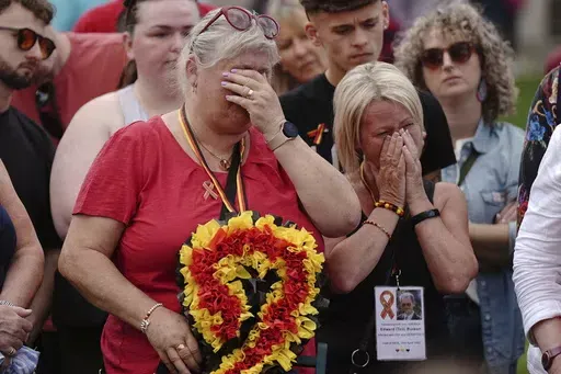 Infected blood campaigners react as they gather in Parliament Square, ahead of the publication of the final report into the scandal, in London, Sunday, May 19, 2024. The final report of the U.K.’s infected blood inquiry will be published Monday, six years after it started its work. The inquiry heard evidence as to how thousands of people contracted HIV or hepatitis from transfusions of tainted blood and blood products in the 1970s and 1980s. (Aaron Chown/PA via AP)