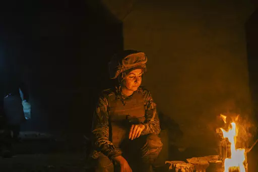 In this photo provided by Azov Special Forces Regiment of the Ukrainian National Guard Press Office, A Ukrainian woman soldier inside the ruined Azovstal steel plant take a rest in his shelter in Mariupol, Ukraine, May 10, 2022. For nearly three months, Azovstal’s garrison clung on, refusing to be winkled out from the tunnels and bunkers under the ruins of the labyrinthine mill. A Ukrainian soldier-photographer documented the events and sent them to the world. Now he is a prisoner of the Russi
