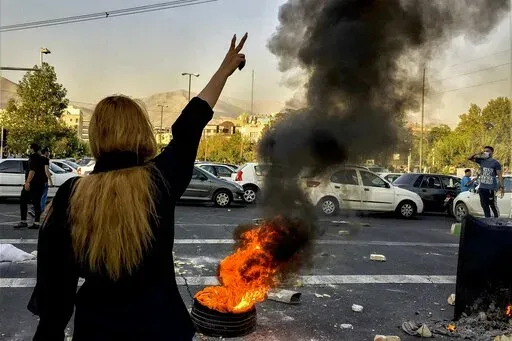 In this photo taken by an individual not employed by the Associated Press and obtained by the AP outside Iran, Iranians protests the death of 22-year-old Mahsa Amini after she was detained by the morality police, in Tehran, Oct. 1, 2022. In a report published by The Iranian student news agency, Nezamoddin Mousavi, an Iranian lawmaker said Sunday, Dec. 4, 2022, that Iran’s government was ‘‘paying attention to the people’s real demands,’’ a day after another key official announced that