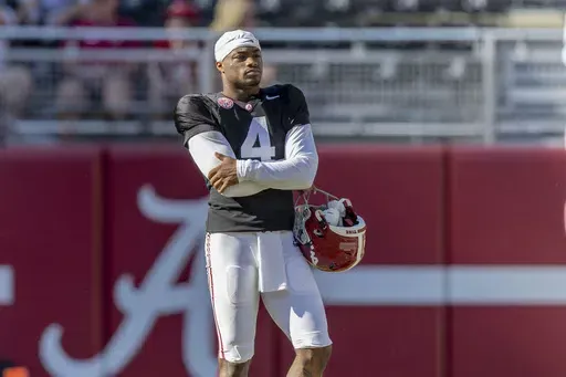 Alabama quarterback Jalen Milroe (4) watches from the edge of the field during the team's A-Day NCAA college football scrimmage Saturday, April 13, 2024, in Tuscaloosa, Ala. (AP Photo/Vasha Hunt)
