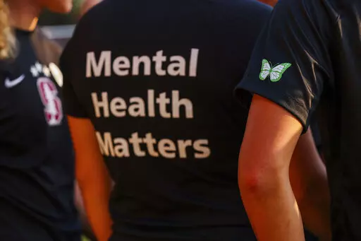 Stanford women's soccer team players wear warmup jerseys with "Mental Health Matters" on their backs as well as a butterfly patch on their sleeves to remember late goalie Katie Meyer, who died by suicide earlier in the year, before an NCAA college soccer match against UCLA, Oct. 14, 2022, in Stanford, Calif. The COVID-19 pandemic took an especially harsh toll on U.S. teen girls’ mental health, with almost 60% reporting feelings of persistent sadness or hopelessness, according to a government s