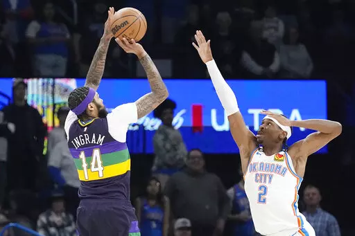 New Orleans Pelicans forward Brandon Ingram (14) shoots over Oklahoma City Thunder guard Shai Gilgeous-Alexander (2) in the first half of an NBA basketball game Monday, Feb. 13, 2023, in Oklahoma City. (AP Photo/Sue Ogrocki)
