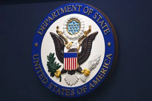 The State Department seal is seen on the briefing room lectern at the State Department in Washington, Jan. 31, 2022. Everyday Americans will be able to help refugees adjust to life in the U.S. in a program being launched by the State Department. The goal is to give private citizens a role in resettling the thousands of refugees who come to America every year. The State Department is calling the new program the Welcome Corps.(Mandel Ngan, Pool via AP, File)