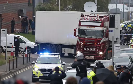 Police escort the truck, that was found to contain a large number of dead bodies, as they move it from an industrial estate in Thurrock, south England, Oct. 23, 2019. The final member convicted in a London court for a migrant smuggling ring that was responsible for the deaths of 39 Vietnamese immigrants who suffocated in a shipping container was sentenced Thursday Nov. 30, 2023. (AP Photo/Alastair Grant, File)