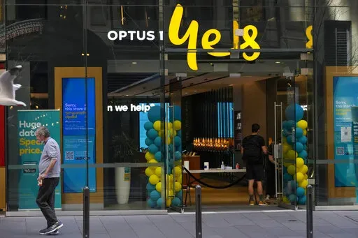 A customer waits for service at a Optus phone store in Sydney, Australia, Thursday, Oct. 7, 2021. The Australian government said on Monday, Sept. 26, 2022, it was considering tougher cybersecurity rules for telecommunications companies after Optus, the nation’s second-largest wireless carrier, reported personal data of 9.8 million customers had been breached. (AP Photo/Mark Baker, File)