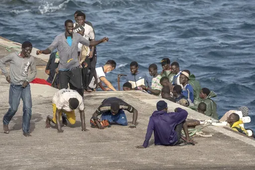 Migrants react as they arrive at the port in La Restinga on the Canary island of El Hierro, Spain, on, Aug. 19, 2024. (AP Photo/Maria Ximena, File)
