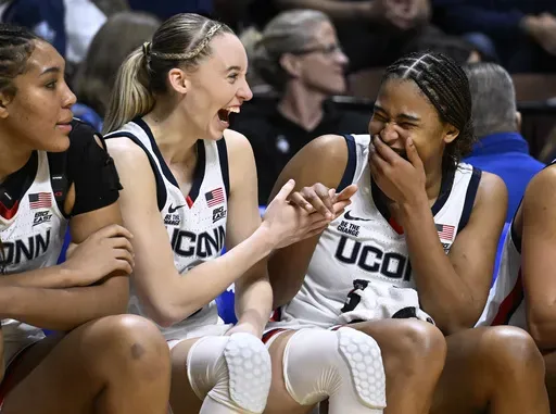 UConn guard Paige Bueckers, second from left, and forward Sarah Strong, right, laugh during the second half of an NCAA college basketball game against Villanova in the semifinals of the Big East Conference tournament, Sunday, March 9, 2025, in Uncasville, Conn. (AP Photo/Jessica Hill)