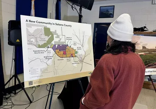 A map of a new proposed community in Solano County, Calif., is displayed during a news conference in Rio Vista, Calif. on Jan. 17, 2024. A Silicon Valley-backed initiative to build a green city for up to 400,000 people in the San Francisco Bay Area has qualified for the Nov. 5 ballot. Voters will be asked to allow urban development on land currently zoned for agriculture. (AP Photo/Janie Har, File)
