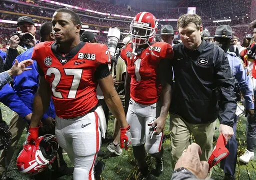Georgia's Nick Chubb, from left, Sony Michel and Kirby Smart walk off the field as Georgia loses to Alabama in the NCAA college football playoff championship game in Atlanta on Monday, Jan. 8, 2018. Alabama won, 26-23. Those Georgia Bulldogs aren't the only ones having a devil of a time beating fellow Southeastern Conference powerhouse Alabama. (Curtis Compton/Atlanta Journal-Constitution via AP, File)