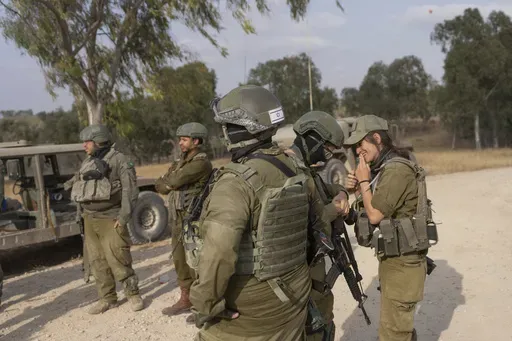 Israeli soldiers gather near the Israeli-Gaza border in southern Israel before they enter Gaza Strip, Wednesday, May 1, 2024. (AP Photo/Ohad Zwigenberg)