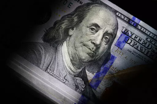 The likeness of Benjamin Franklin is seen on U.S. $100 bills, Thursday, July 14, 2022, in Marple Township, Pa.  Debt can derail a person’s financial goals and take a toll on their mental health. And if they’ve been turning to you or others for money, those struggles can spread quickly. But as a close friend or relative, you have the potential to set them on the right course.  (AP Photo/Matt Slocum)