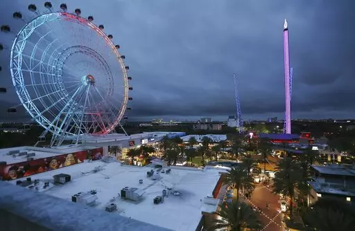 ICON Park attractions, The Wheel, left, Orlando SlingShot, middle, and Orlando FreeFall, right, are shown in Orlando, Fla., on Thursday, March 24, 2022.   A 14-year-old boy fell to his death from a ride at an amusement park in Orlando, sheriff's officials said. Sheriff's officials and emergency crews responded to a call late Thursday at Icon Park, which is located in the city's tourist district along International Drive. The boy fell from the Orlando Free Fall ride, which opened late last year.(
