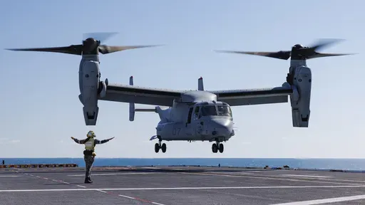 Royal Australian Navy sailor Leading Seaman Keely Hagedoorn guides a U.S. Marine Corps MV-22 Osprey during take-off and landing practice on the flight deck of HMAS Adelaide in the Whitsunday Islands off the coast of Australia during Exercise Sea Raider, Aug. 7, 2023. (Sgt. Andrew Sleeman/Royal Australian Navy via AP)