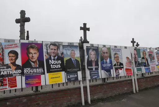 Electoral posters displaying the presidential candidates is displayed in Aubers, northern France, Friday, April 8, 2022. France's first round of the presidential election takes place on April 10, with a presidential runoff on April 24 if no candidate wins outright. (AP Photo/Michel Spingler)