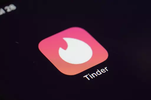 The icon for the dating app Tinder appears on a device, July 28, 2020, in New York. Tinder, Hinge and other dating apps are designed with addictive features that encourage “compulsive” use, a proposed class action lawsuit against parent company Match Group claims. The lawsuit filed Wednesday, Feb. 14, 2024, says Match intentionally designs its dating platforms with game-like features that “lock users into a perpetual pay-to-play loop” prioritizing profit over promises to help users find 