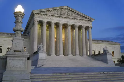 Light illuminates part of the Supreme Court building at dusk on Capitol Hill in Washington, Nov. 16, 2022. In courtrooms across America, defendants get additional prison time for crimes that juries found they didn’t commit. The Supreme Court is being asked, again, to put an end to the practice.(AP Photo/Patrick Semansky, File)