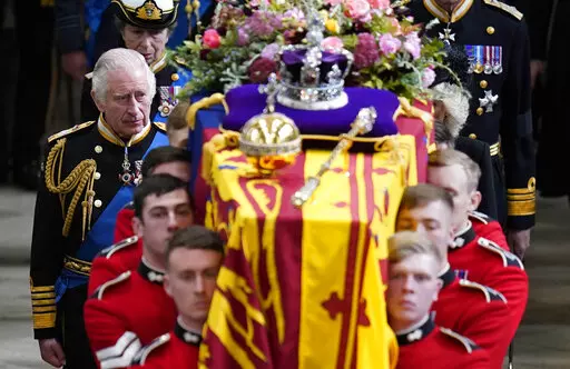 King Charles III and members of the Royal family follow behind the coffin of Queen Elizabeth II, draped in the Royal Standard with the Imperial State Crown and the Sovereign's orb and sceptre, as it is carried out of Westminster Abbey after her State Funeral, in London, Monday Sept. 19, 2022. The Queen died on Sept. 8 at 96. (Danny Lawson/Pool Photo via AP, File)