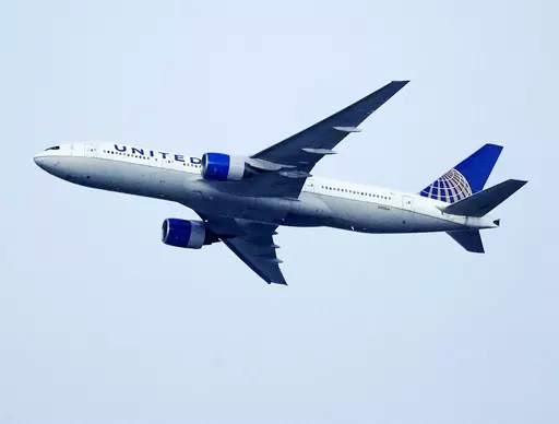 A United Airlines jetliner soars past an MLS soccer match July 8, 2023, in Commerce City, Colo. United Airlines and the union representing its pilots said Saturday, July 15, 2023, they reached agreement on a contract that will raise pilot pay by up to 40% over four years. (AP Photo/David Zalubowski, File)