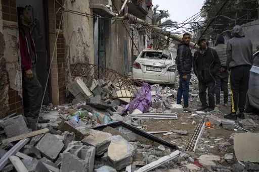 Palestinians look at the destruction after an Israeli airstrike in Rafah, Gaza Strip, Friday, Feb. 9, 2024. (AP Photo/Fatima Shbair)