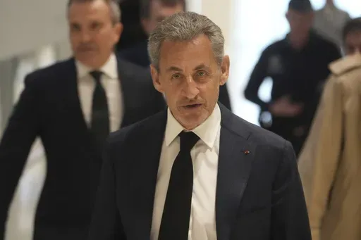 Former French President Nicolas Sarkozy arrives as he goes on trial over alleged illegal financing of his 2007 presidential campaign by the government of late Libyan leader Moammar Gadhafi, Monday, Jan. 6, 2025 in Paris. (AP Photo/Thibault Camus, File)
