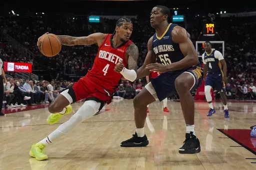 Houston Rockets guard Jalen Green (4) controls the ball against New Orleans Pelicans center Trey Jemison III (55) during the first half of an NBA basketball game in Houston, Thursday, Dec. 19, 2024. (AP Photo/Ashley Landis)