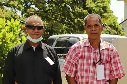 CORRECTS ID OF A PERSON AT RIGHT - Survivors Sulaki Kafoika, left, and Sione Vailea pose for a photo in Nukuʻalofa, Tonga on Feb. 22, 2022. Kafoika and Havea were on Mango Island in Tonga, one of the closest islands to the Jan. 15 volcanic eruption that was so huge it echoed around the world. Every single home on the island was destroyed by the tsunami that followed. (Aloma Johansson/Tonga Red Cross/IFRC via AP)