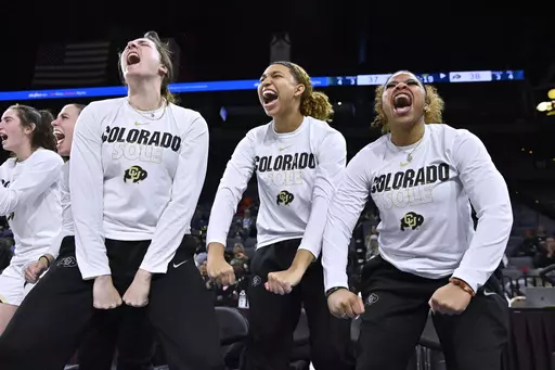 Colorado players, from left, Ally Fitzgerald, Mikayla Johnson and Shelomi Sanders, react after a 3-point basket against Oregon State during the second half of an NCAA college basketball game in the quarterfinals of the Pac-12 women's tournament, Thursday, March 2, 2023, in Las Vegas. When Deion Sanders arrived in Boulder to resurrect the University of Colorado's slumbering football program he not only brought his sons Sheduer, a star quarterback, and Shilo, a star safety, but also his youngest c