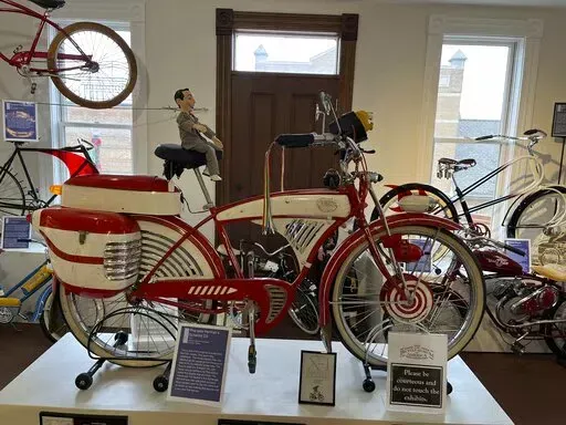 This modified 1953 Schwinn DX that was used in the 1985 film "Pee-wee’s Big Adventure," starring Paul Reubens as Pee-wee Herman, appears at the Bicycle Museum of America in New Bremen, Ohio on Dec. 26, 2022. The museum traces the bike's impact on culture, transportation and plain ol’ fun, showing how it became synonymous with convenience and ease. (Steve Wartenberg via AP)