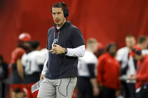 Cincinnati head coach Luke Fickell stands on the field during an NCAA football intrasquad scrimmage, Saturday, April 9, 2022, in Cincinnati. The sixth-year Cincinnati coach is tasked with following up a historic 2021 season that saw the Bearcats become the first team outside a Power Five conference to crack the College Football Playoff. (AP Photo/Aaron Doster, File)