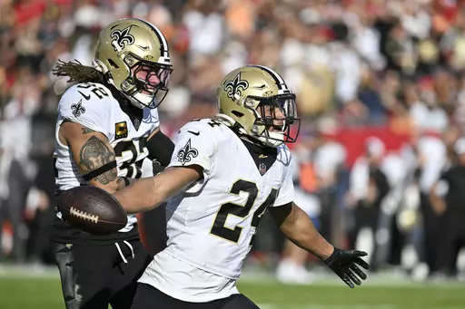 New Orleans Saints safety Johnathan Abram (24) celebrates his interception with safety Tyrann Mathieu (32) in the second half of an NFL football game against the Tampa Bay Buccaneers in Tampa, Fla., Sunday, Dec. 31, 2023. (AP Photo/Jason Behnken)