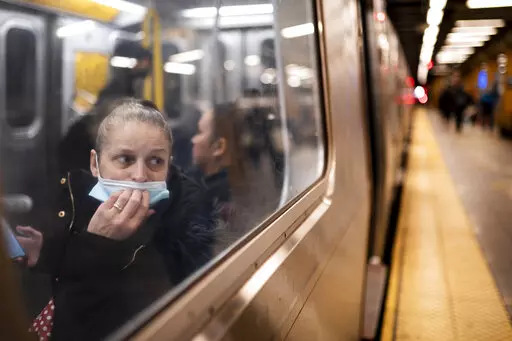 A passenger looks out onto the platform while riding a northbound train in 36th Street subway station where a shooting attack occurred the previous day during the morning commute, Wednesday, April 13, 2022, in New York.  Mayor Eric Adams said Wednesday that officials were now seeking 62-year-old Frank R. James as a suspect. (AP Photo/John Minchillo)