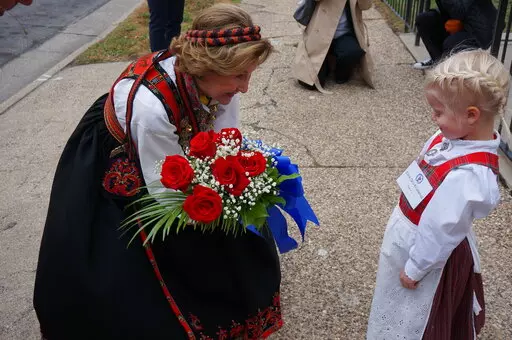 Eline Gro Knatterud, 4, greets Queen Sonja of Norway as she arrives to Den Norske Lutherske Mindekirke, the Norwegian Lutheran Memorial Church in Minneapolis, Sunday Oct. 16, 2022. (AP Photo/Giovanna Dell'Orto)