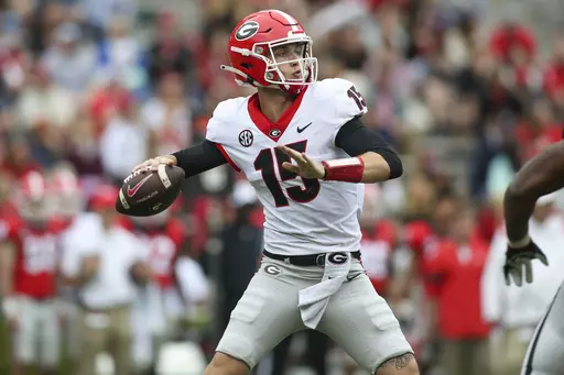 Georgia quarterback Carson Beck (15) throws in the first half of Georgia's spring NCAA college football game, Saturday, April 16, 2022, in Athens, Ga. Coach Kirby Smart has made it clear that Carson Beck is the quarterback to beat. (AP Photo/Brett Davis, File)