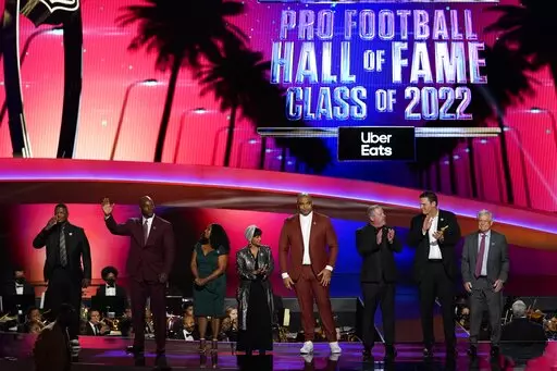 The 2022 NFL Football Hall of Fame class is seen during the NFL Honors show Thursday, Feb. 10, 2022, in Inglewood, Calif. The class is: Tony Boselli, LeRoy Butler, Sam Mills, Richard Seymour, Bryant Young, Cliff Branch, Art McNally and Dick Vermeil. Filling in for Sam Mills is Melanie Mills and filling in for Tony Boselli is Elain Anderson. (AP Photo/Mark J. Terrill)