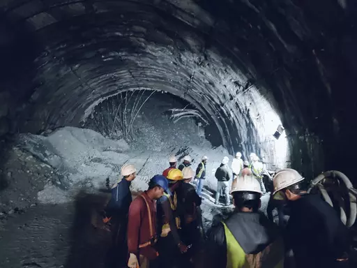 This photo provided by Uttarakhand State Disaster Response Force (SDRF) shows rescuers inside a collapsed road tunnel where more than 30 workers were trapped by a landslide in northern in Uttarakhand state, India, Sunday, Nov.12, 2023. ( SDRF via AP)