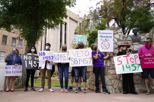 A number of Arizona reproductive health, rights, and justice advocates protest an abortion bill at the Arizona Capitol on Monday, April 26, 2021, in Phoenix. The Arizona Legislature has approved a ban on abortion after 15 weeks. The House approved the measure Thursday, March 24, 2022, a month after the Senate gave its ok, and it now heads to Republican Gov. Doug Ducey for his expected signature. (AP Photo/Ross D. Franklin, File)