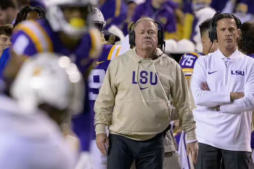LSU head coach Brian Kelly, center, watches from the sideline during the second half of an NCAA college football game against Georgia State in Baton Rouge, La., Saturday, Nov. 18, 2023. (AP Photo/Matthew Hinton, File)
