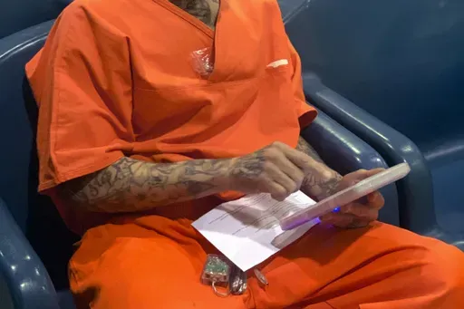 In this image provided by the North Fork Correctional Center in Sayre, Okla., on Tuesday, June 9, 2021, an inmate Byron Robinson works on a tablet, which are being provided for free to Oklahoma inmates as part of a new program by the Department of Corrections. (Lance West/Oklahoma Department of Corrections via AP)