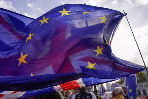 A Union flag waves behind a European Union flag, outside the Houses of Parliament, in London, Wednesday, Oct. 19, 2022. Since the shock 2016 referendum vote to leave the European Union, Britain has seen years of bitter wrangling with the EU, two general elections and three prime ministers. The pound fell 0.75% against the U.S. dollar to $1.1273 in late morning trading in London, after jumping as much as 1.2% on Monday. (AP Photo/Alberto Pezzali)