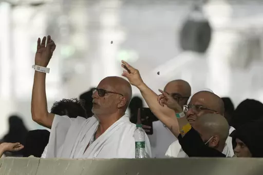 Pilgrims cast stones at a pillar in the symbolic stoning of the devil, the last rite of the annual Hajj pilgrimage, in Mina near the holly city of Mecca, Saudi Arabia, Wednesday, June 28, 2023. (AP Photo/Amr Nabil)