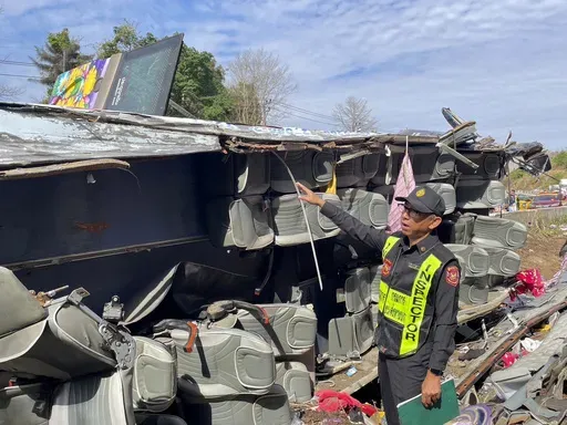 An investigator inspects the accident site where a bus travelling from northern Thailand overturned in eastern Prachinburi province, killing multiple people on Wednesday Feb 26, 2025. (Department of Land Transport via AP)