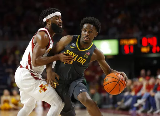Iowa State guard Tre Jackson (3) fouls Baylor guard Adam Flagler (10) during the second half of an NCAA college basketball game, Saturday, Jan. 1, 2022, in Ames, Iowa. Baylor won 77-72. (AP Photo/Matthew Putney)