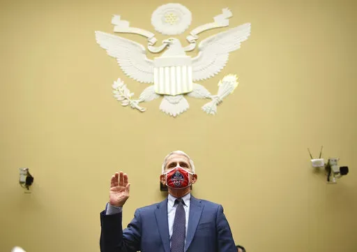 Dr. Anthony Fauci, director of the National Institute for Allergy and Infectious Diseases, is sworn in before a House Subcommittee on the Coronavirus crisis hearing, July 31, 2020 on Capitol Hill in Washington. Fauci steps down from a five-decade career in public service at the end of the month, one shaped by the HIV pandemic early on and the COVID-19 pandemic at the end. (Kevin Dietsch/Pool via AP, File)