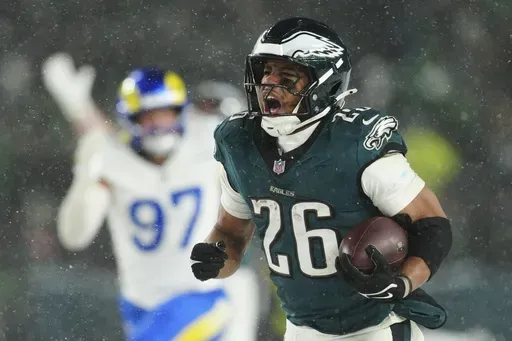 Philadelphia Eagles running back Saquon Barkley (26) runs the ball for a touchdown during the second half of an NFL football NFC divisional playoff game against the Los Angeles Rams on Sunday, Jan. 19, 2025, in Philadelphia. (AP Photo/Derik Hamilton)